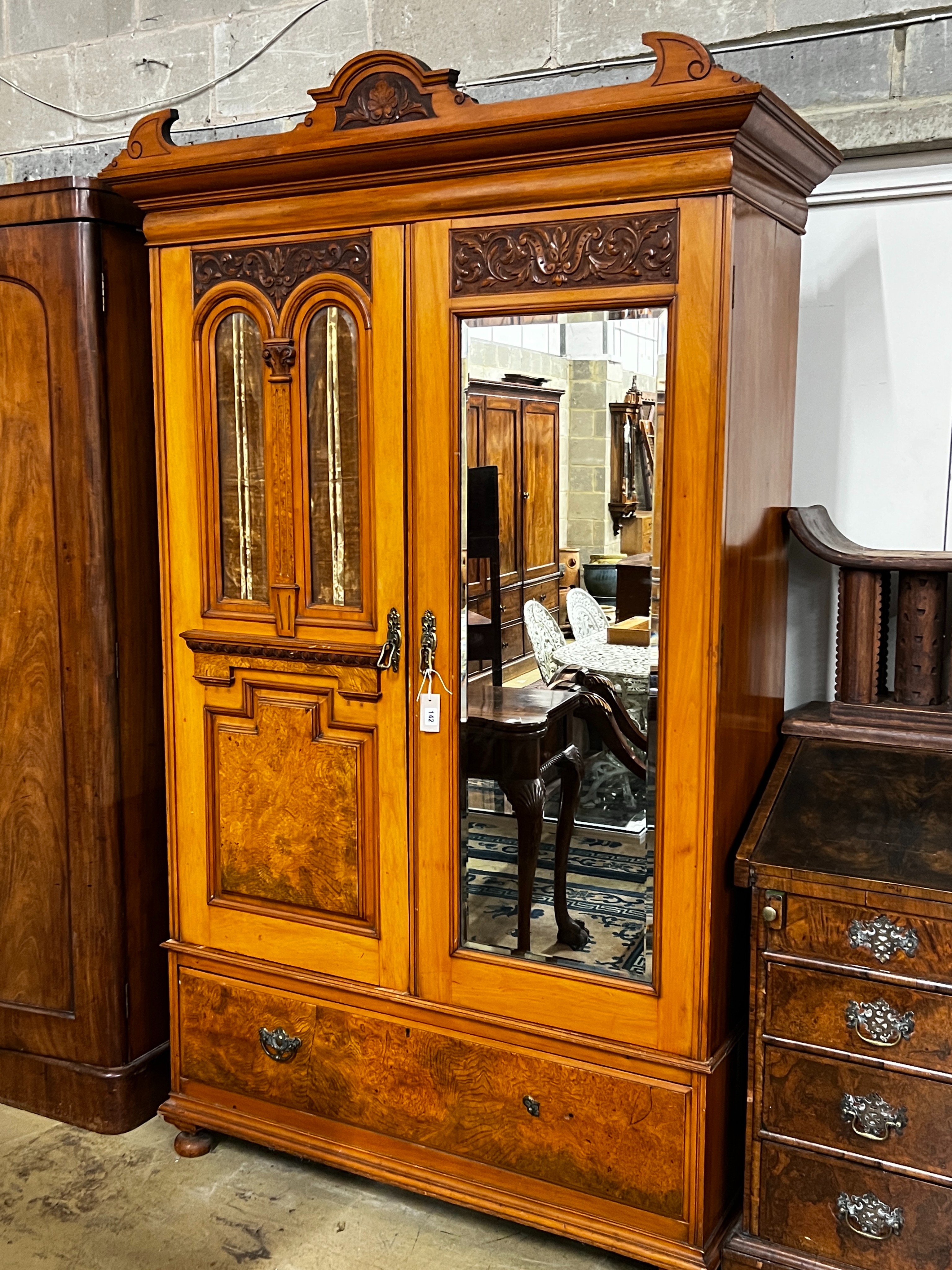 A late Victorian satin walnut and burr elm two door mirrored wardrobe, width 130cm, depth 50cm, height 210cm